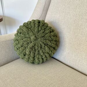 Green poof, pillow, home decor.